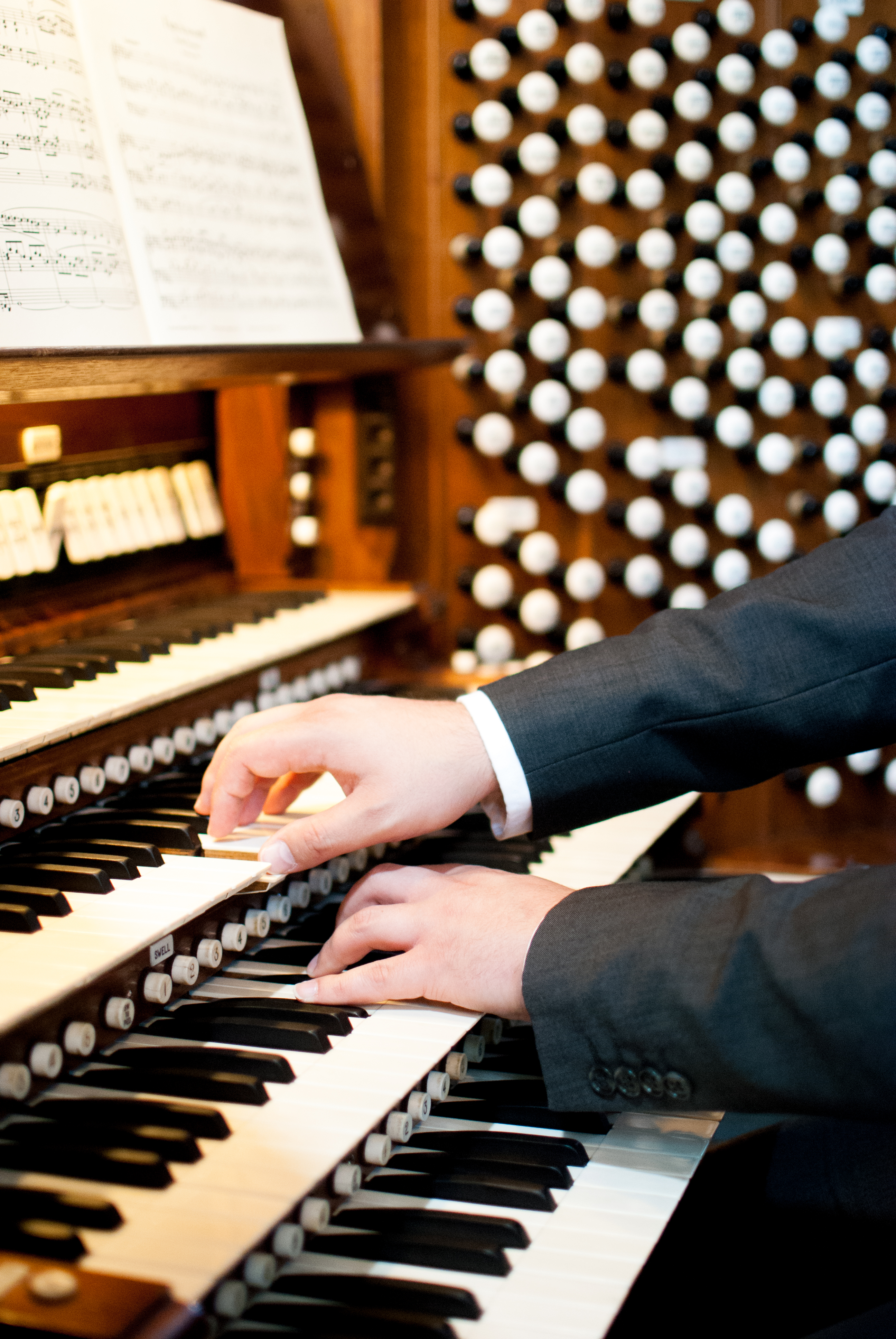 Close-up of Bradley's hands, playing on two different organ manuals